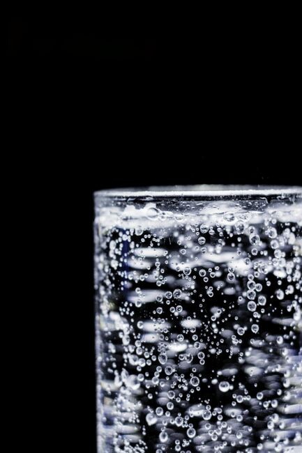 Glass of sparkling water with bubbles